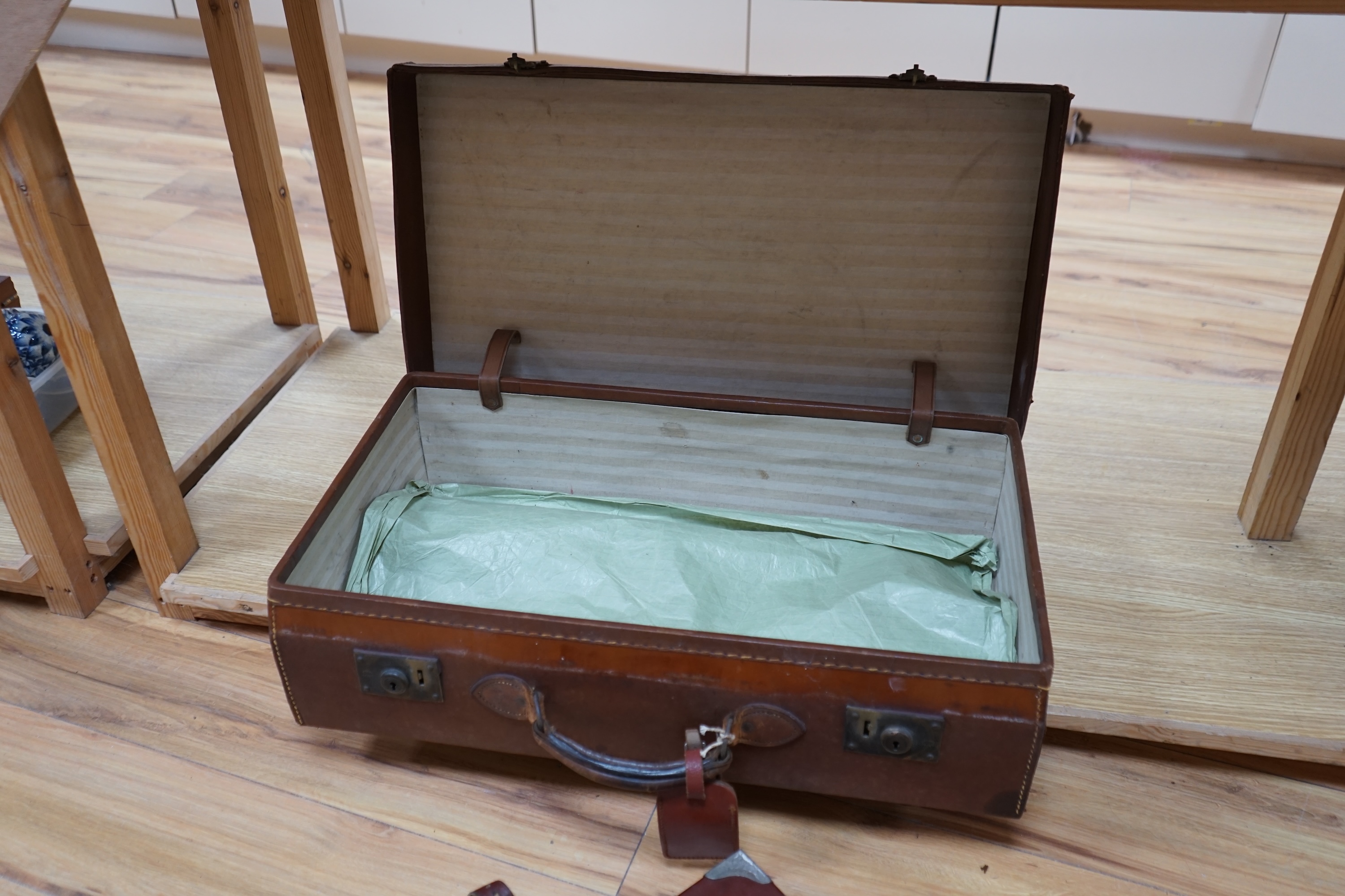 A gun case, various gun cleaning equipment and a brown leather suitcase. Condition - fair